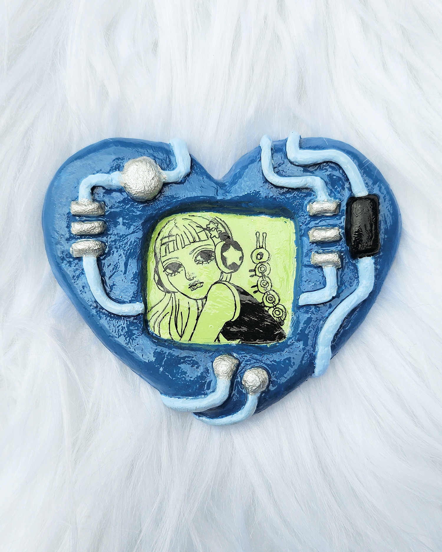 Blue Heart-shaped clay sculpture with a screen shape in the middle with a pen drawing for a y2k girl and a caterpillar. There are circuit board and retro tech aesthetics on the heart shape. 