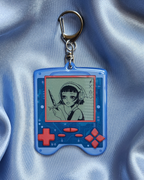 Lenticular Keychain of a game device with a girl wearing headphones and wielding a sword.