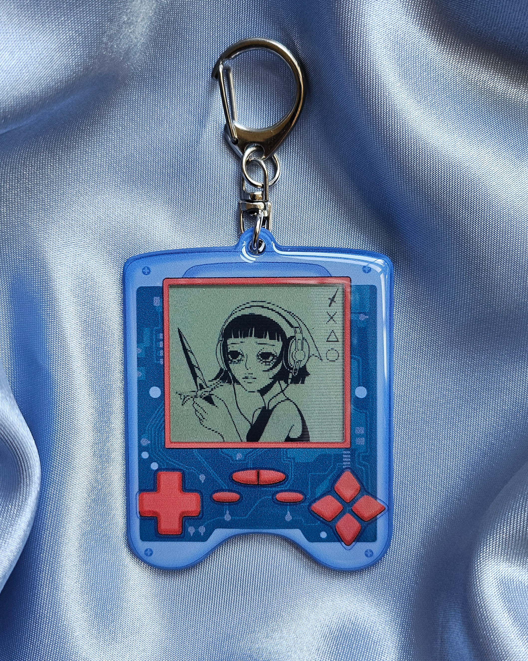 Lenticular Keychain of a game device with a girl wearing headphones and wielding a sword.