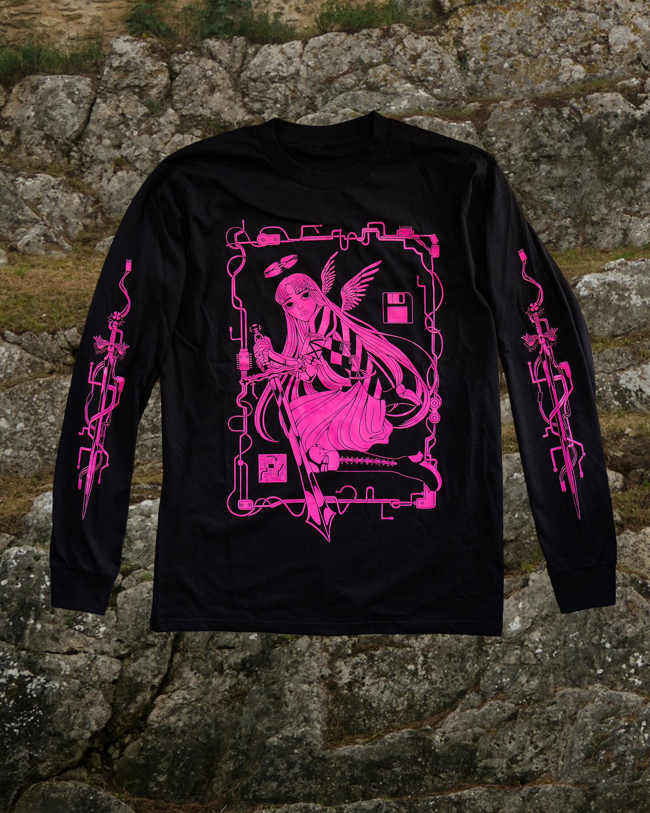 Black long-sleeve shirt with pink graphic design of an angel holding a sword screen-printed on it. She has a CD halo on her head and there rectangular is a border made of wires surrounding her. The sleeves have sword designs on each arm. 

